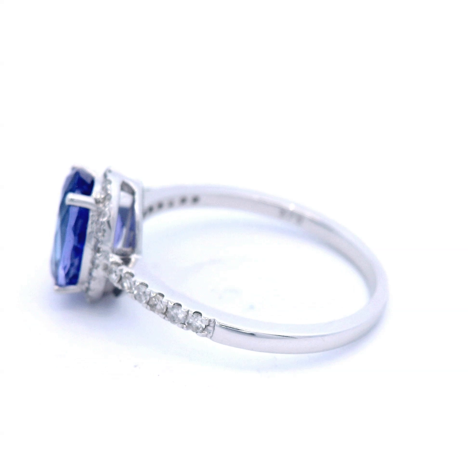 Oval Cut Tanzanite Dress Ring with Diamond Halo and Shoulder in White Gold