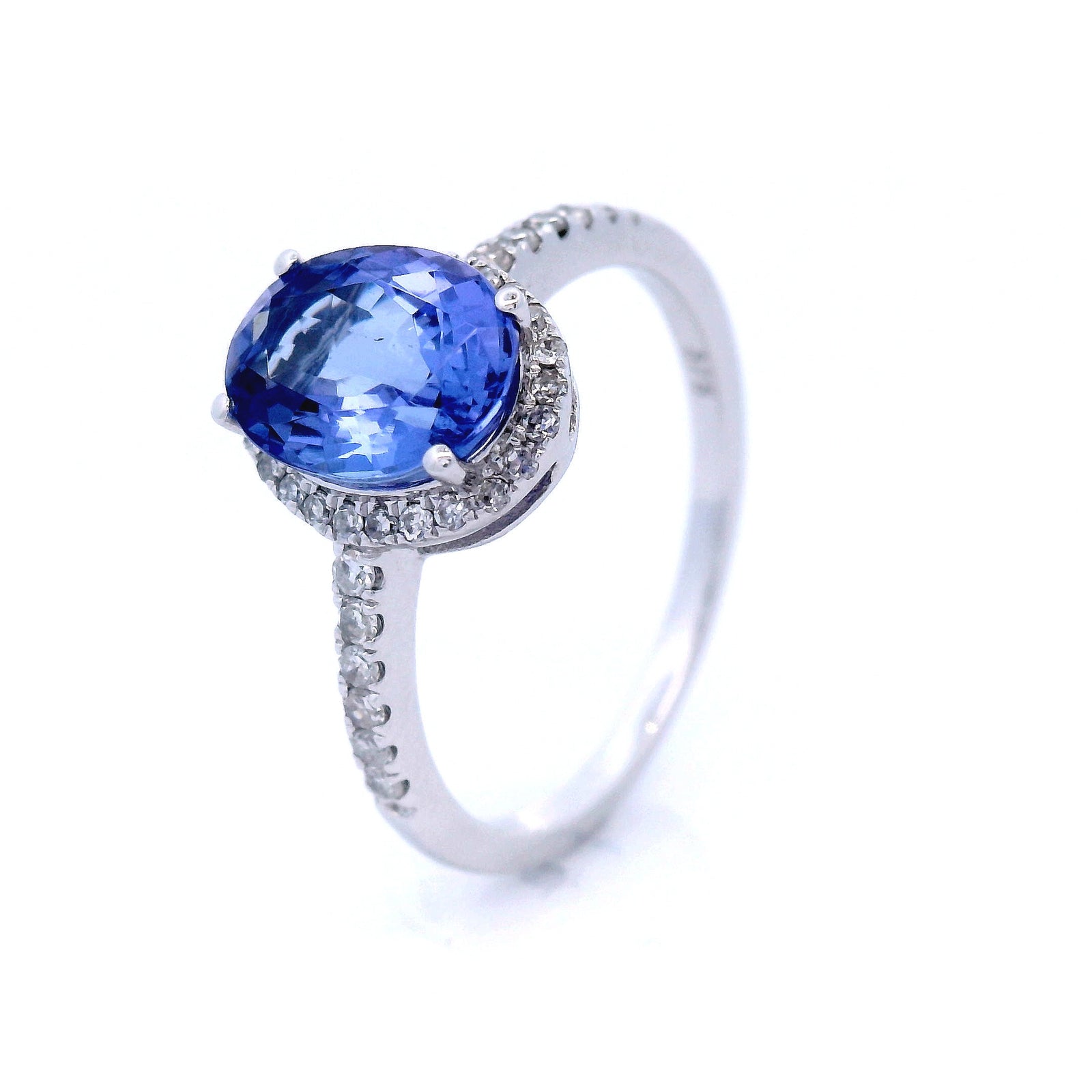 Oval Cut Tanzanite Dress Ring with Diamond Halo and Shoulder in White Gold