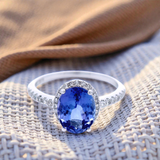 Oval Cut Tanzanite Dress Ring with Diamond Halo and Shoulder  in White Gold