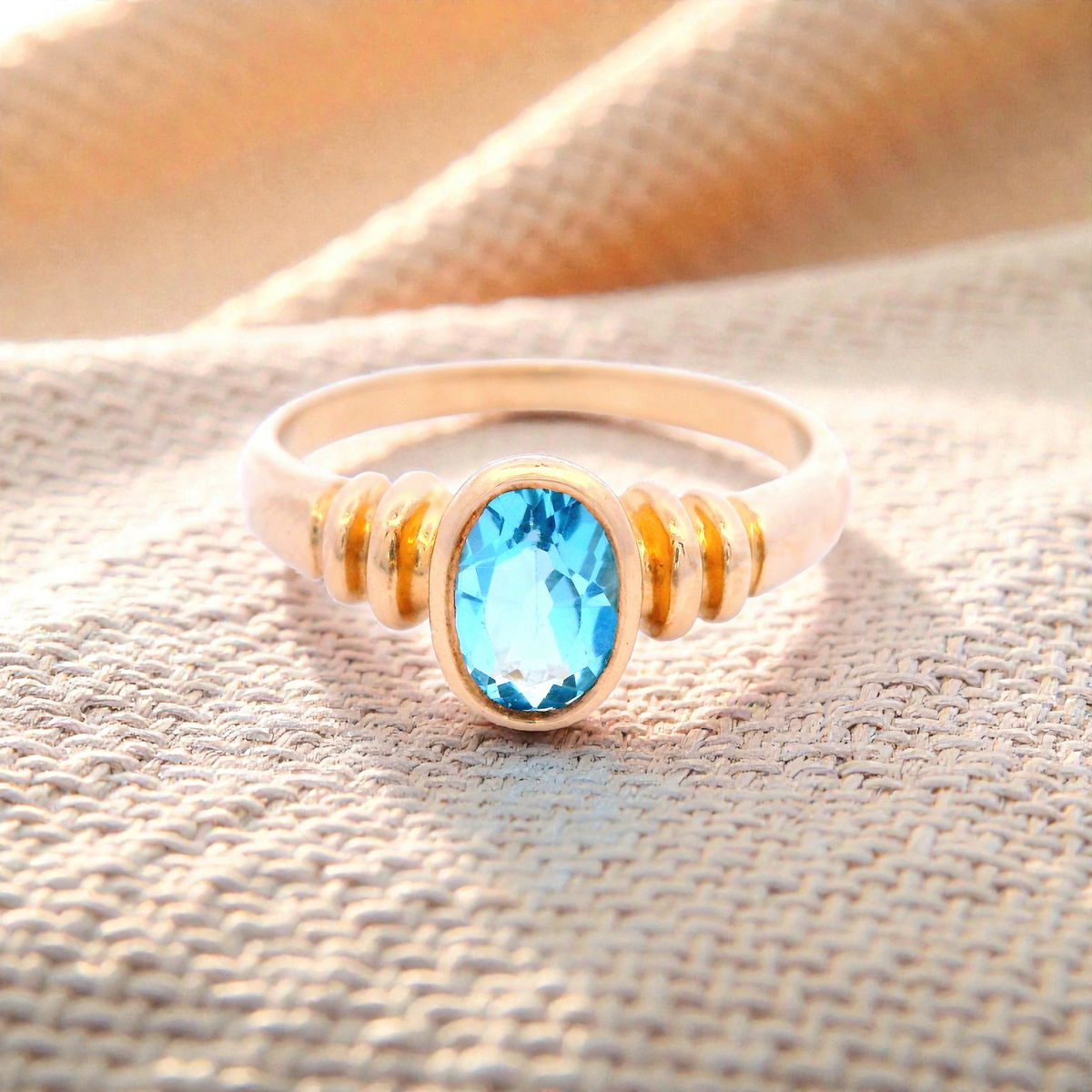 Oval Blue Topaz Set in Yellow Gold