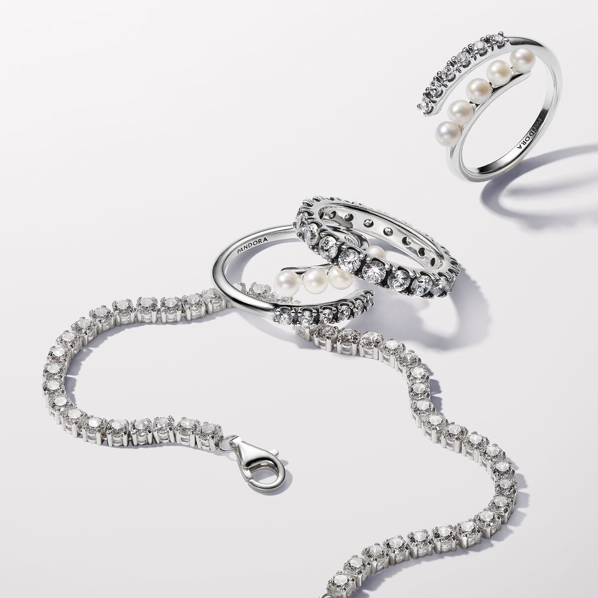 Sterling silver open ring with white treated freshwater cultured pearl and clear cubic zirconia