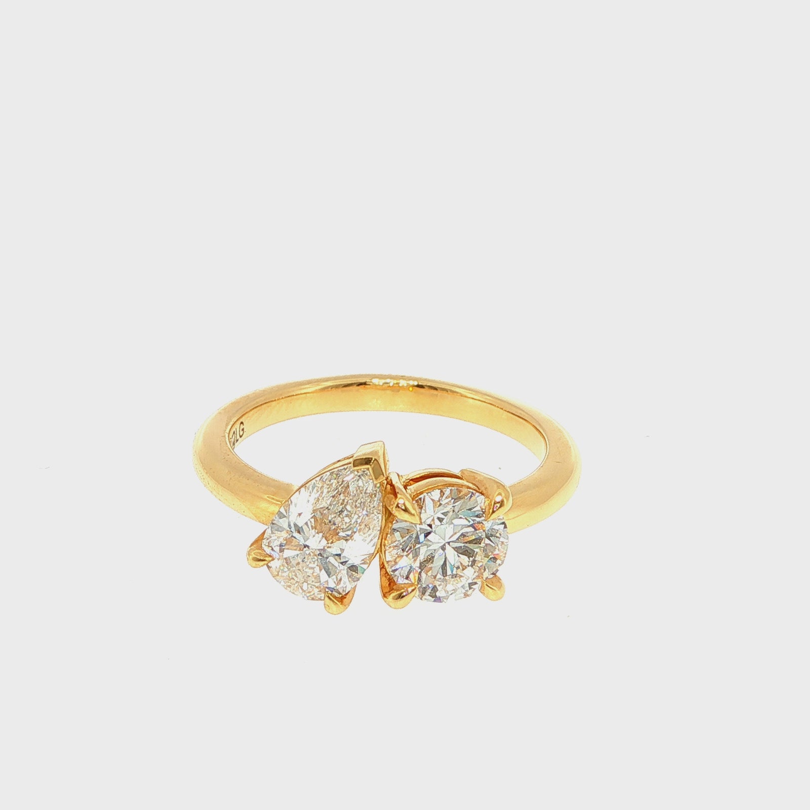 Round and Pear Shaped Diamonds Set in Yellow Gold